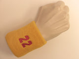 Golden yellow wristband sweatband with number 22