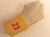 Golden yellow wristband sweatband with number 23