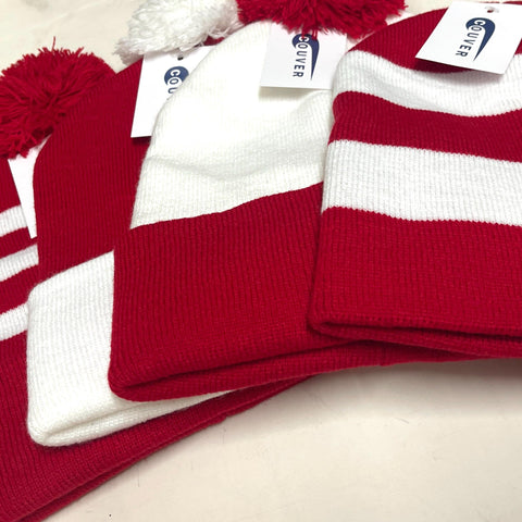 Collection of red and white knit beanies with pom-poms