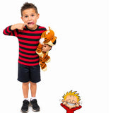 Child wearing red and black striped shirt holding tiger plush