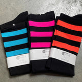 Three pairs of black knee-high socks with blue, hot pink and neon orange stripes