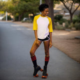 Black knee-high socks with red stripes styled with roller skates