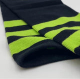 Black knee-high socks with neon green striped cuff