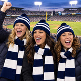 Fans wearing navy and white striped pom beanies and scarves at a game